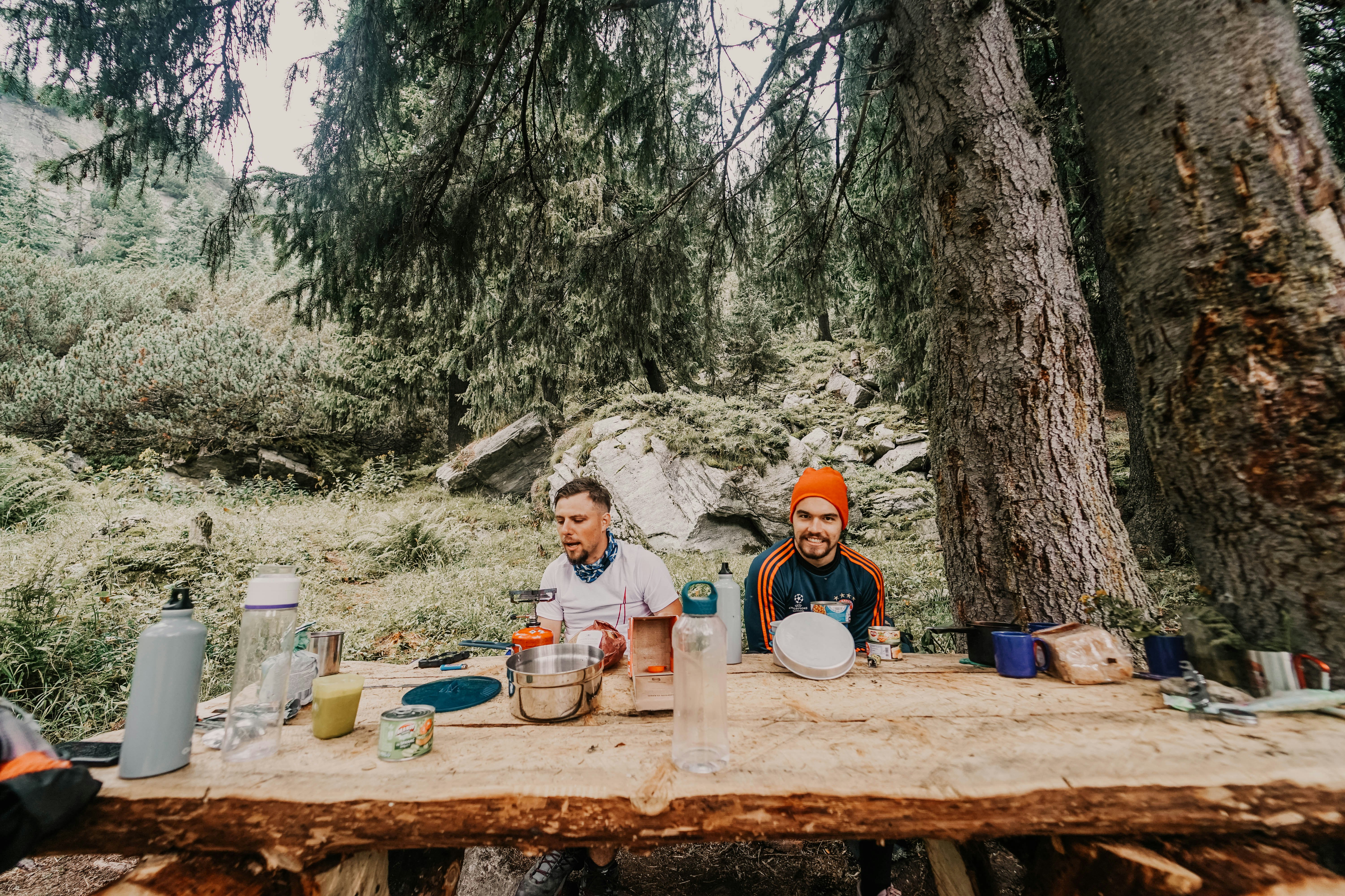 two persons sitting in front of stump table